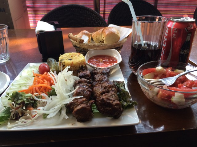 lamb kebabs, rice, bread, and plenty of veggies