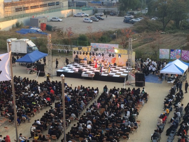 the stage and cheering students